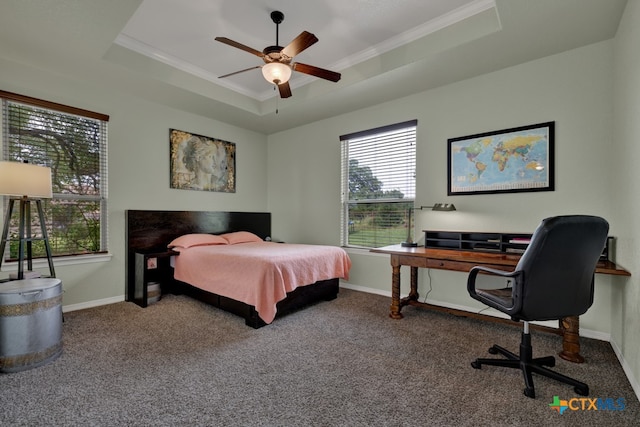 carpeted bedroom featuring a raised ceiling, ceiling fan, and crown molding