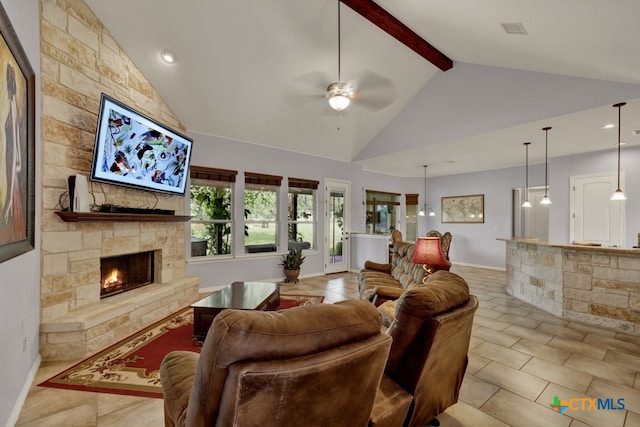 tiled living room featuring beam ceiling, a stone fireplace, ceiling fan, and high vaulted ceiling