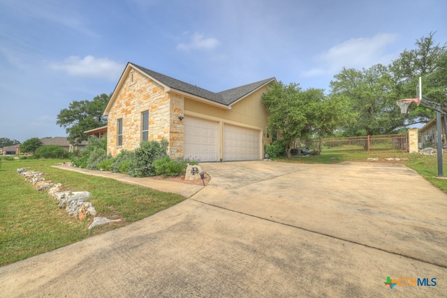 view of side of property with a lawn and a garage