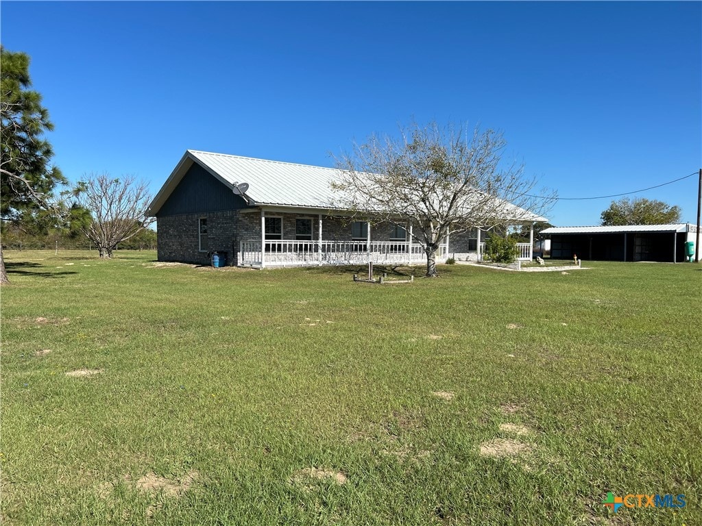 view of front of property featuring a front yard and metal roof