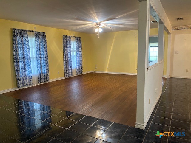 empty room featuring visible vents, baseboards, and tile patterned floors