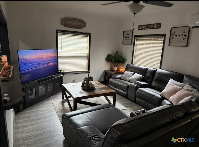 202 Clark St, Yoakum, TX 77995 - living room featuring ceiling fan, wood finished floors, and an AC wall unit