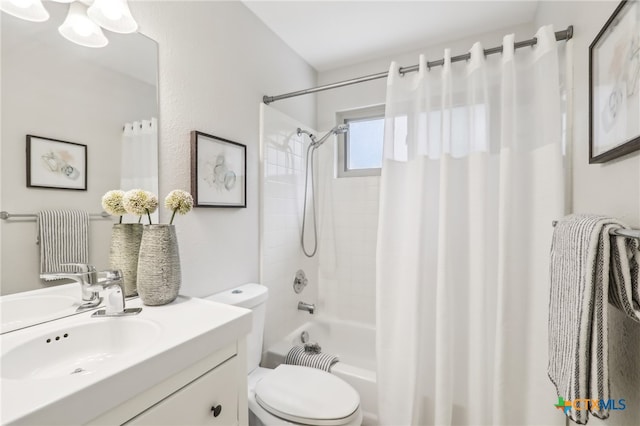 full bath with toilet, vanity, and shower / tub combo with curtain