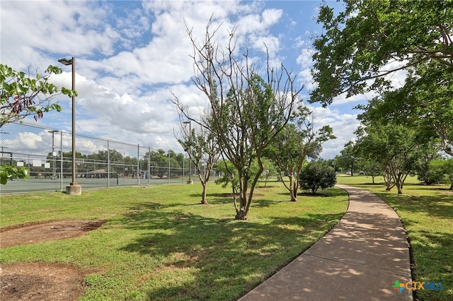 view of property's community featuring a tennis court