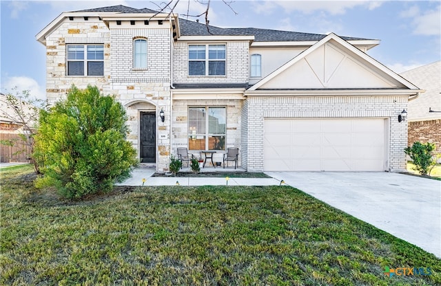 view of front of home featuring a garage and a front lawn