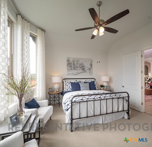 bedroom featuring a ceiling fan, carpet, and vaulted ceiling