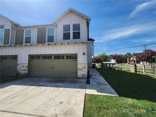 view of front facade with stone siding, driveway, board and batten siding, and an attached garage