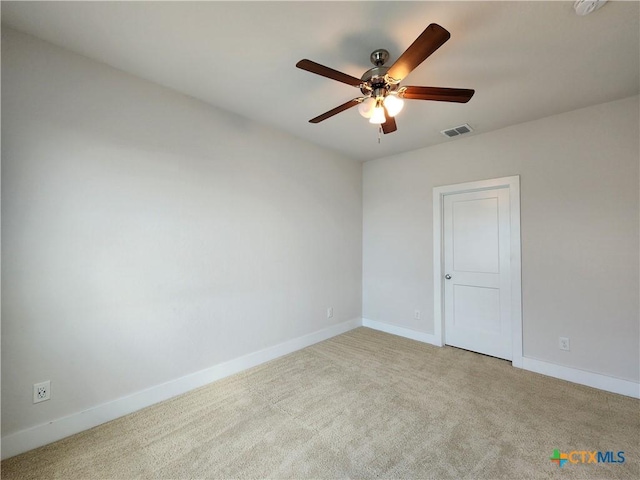 spare room featuring carpet, baseboards, visible vents, and a ceiling fan