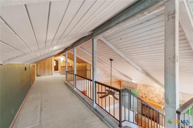2820 Aurora, Horseshoe Bay, TX 78657 - hall with vaulted ceiling, carpet, and wood walls