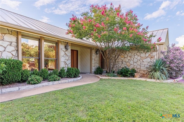 2820 Aurora, Horseshoe Bay, TX 78657 - view of front of property with stone siding, a metal roof, a front yard, and a standing seam roof