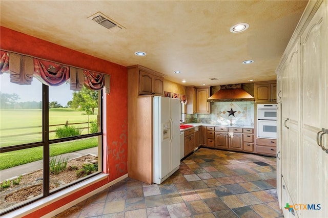 2820 Aurora, Horseshoe Bay, TX 78657 - kitchen with white appliances, custom exhaust hood, dark stone finish floors, light countertops, and recessed lighting
