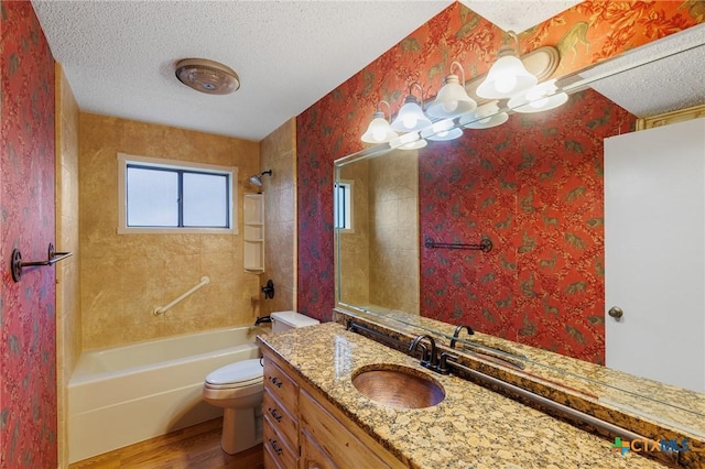 2820 Aurora, Horseshoe Bay, TX 78657 - bathroom featuring wood finished floors, a textured ceiling, vanity, shower / washtub combination, and wallpapered walls