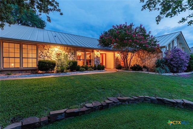2820 Aurora, Horseshoe Bay, TX 78657 - view of front facade featuring a standing seam roof, stone siding, a metal roof, and a front yard