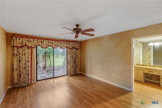 2820 Aurora, Horseshoe Bay, TX 78657 - unfurnished room with wood finished floors, ceiling fan, and a textured ceiling