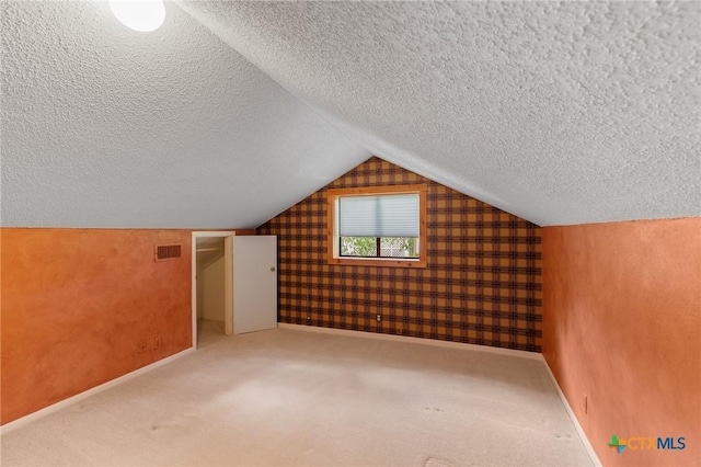 2820 Aurora, Horseshoe Bay, TX 78657 - bonus room with a textured ceiling, vaulted ceiling, and carpet