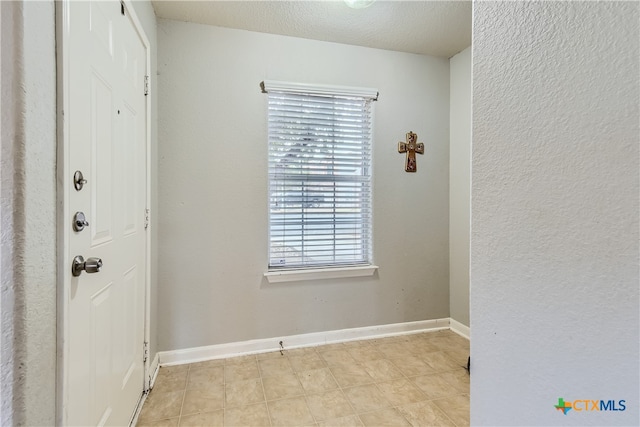 foyer with a textured ceiling