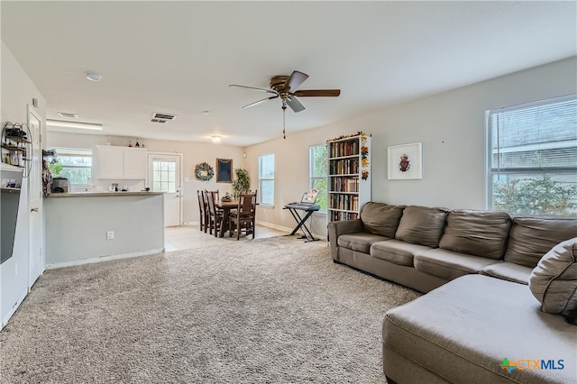 living room featuring ceiling fan and light carpet