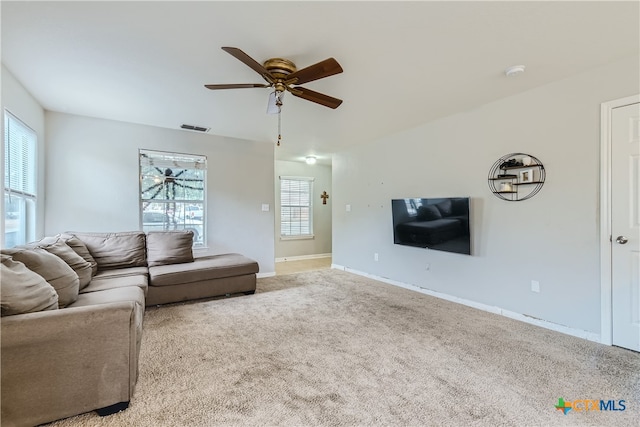 carpeted living room featuring ceiling fan