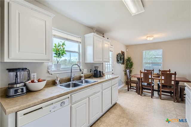 kitchen featuring dishwasher, white cabinets, and sink