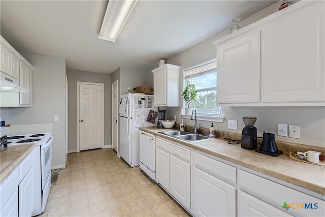 kitchen with white cabinetry, white appliances, and sink