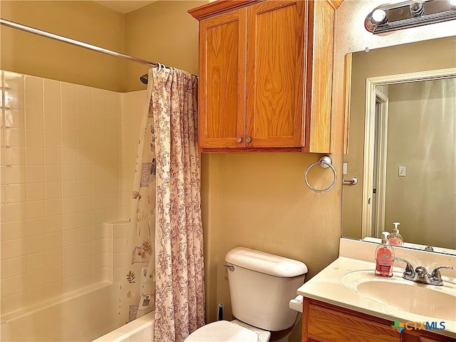 full bathroom featuring toilet, shower / tub combo with curtain, and vanity