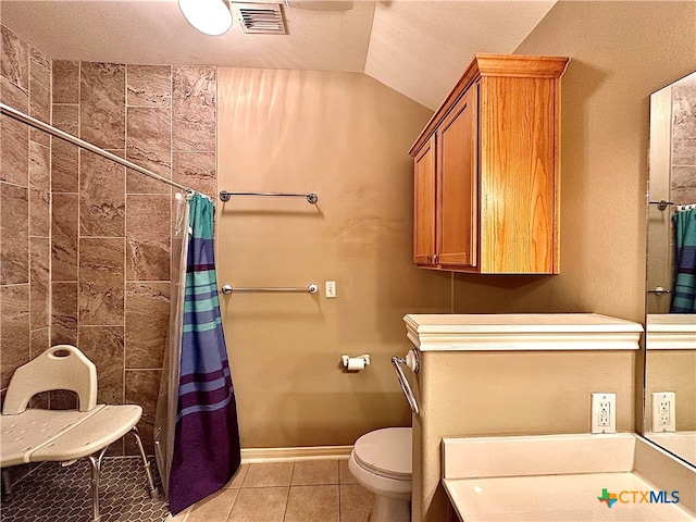 bathroom featuring tile patterned flooring, a textured ceiling, toilet, and vaulted ceiling