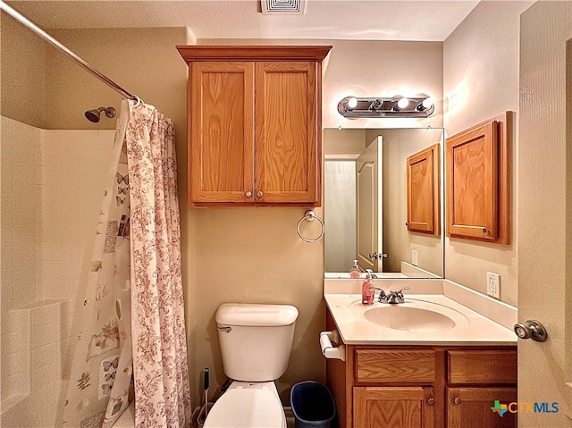 bathroom with vanity, toilet, and a shower with shower curtain