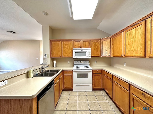 kitchen with sink, kitchen peninsula, light tile patterned floors, white appliances, and lofted ceiling