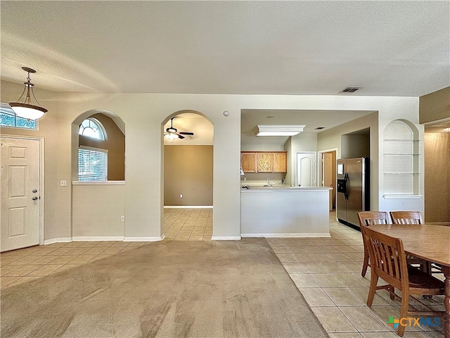 interior space featuring ceiling fan and a textured ceiling