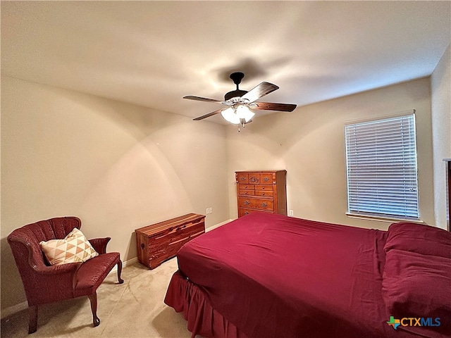 bedroom featuring light carpet and ceiling fan