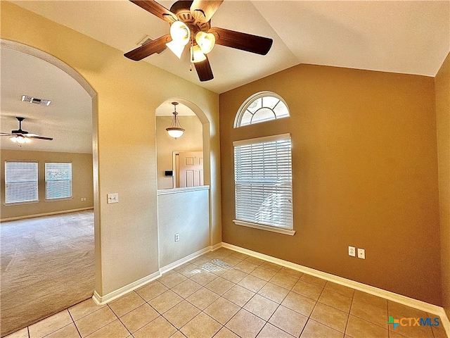 unfurnished room with ceiling fan, light tile patterned floors, and lofted ceiling