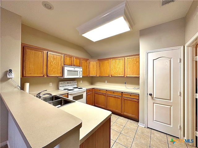 kitchen with light tile patterned flooring, white appliances, sink, kitchen peninsula, and lofted ceiling