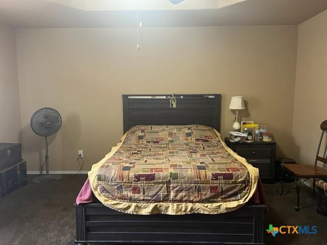 2107 Golden Eagle Dr, Killeen, TX 76549 - bedroom with dark carpet and baseboards