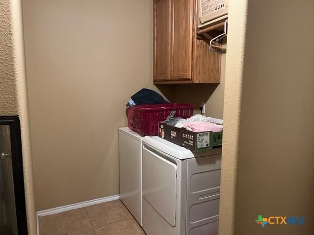 2107 Golden Eagle Dr, Killeen, TX 76549 - laundry area featuring light tile patterned flooring, independent washer and dryer, cabinet space, and baseboards