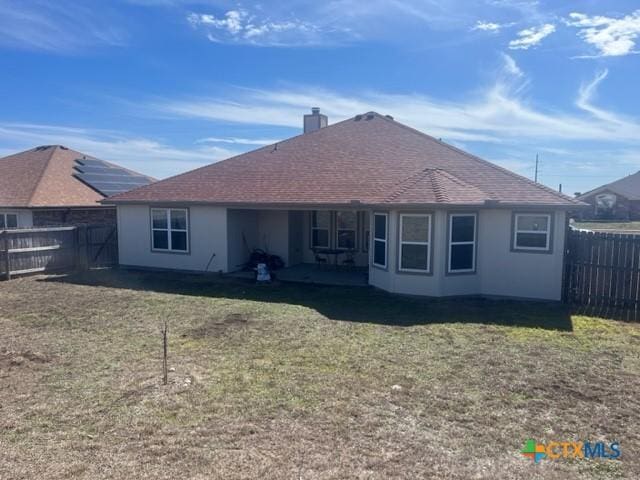 2107 Golden Eagle Dr, Killeen, TX 76549 - rear view of house with a fenced backyard, a shingled roof, and a lawn