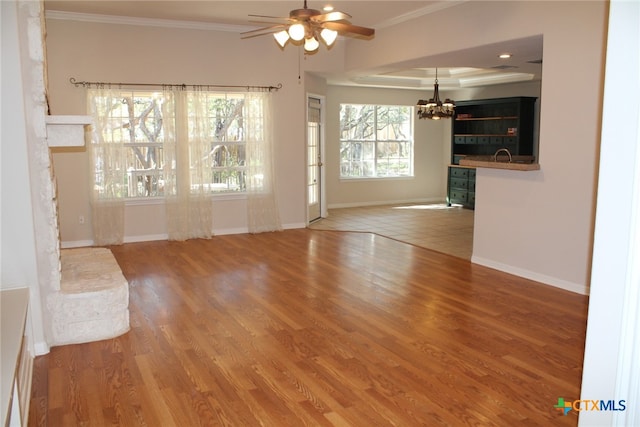 living room with wood-type flooring, ceiling fan, and ornamental molding