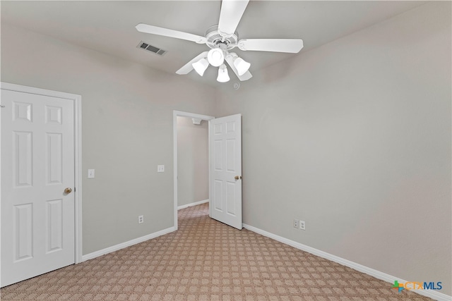 carpeted spare room with ceiling fan