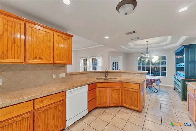 kitchen with kitchen peninsula, backsplash, white dishwasher, sink, and a chandelier