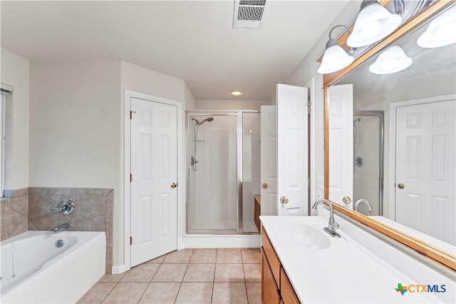 bathroom with tile patterned flooring, vanity, and independent shower and bath