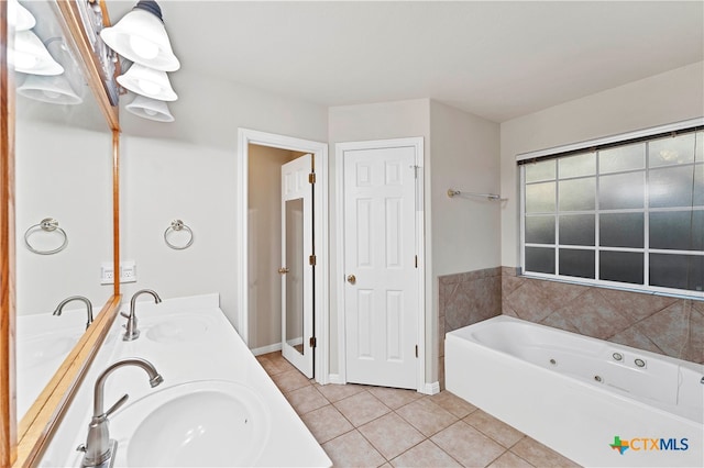 bathroom featuring tile patterned flooring, vanity, and a bathing tub