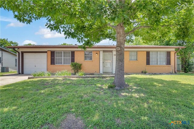 1210 Ridgemont Dr, Killeen, TX 76549 - ranch-style house with an attached garage, driveway, brick siding, a front yard, and cooling unit