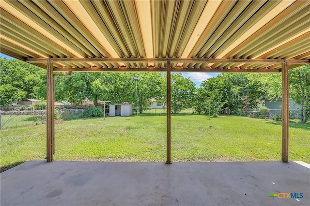 1210 Ridgemont Dr, Killeen, TX 76549 - view of patio with a storage unit, an outbuilding, and view of wooded area