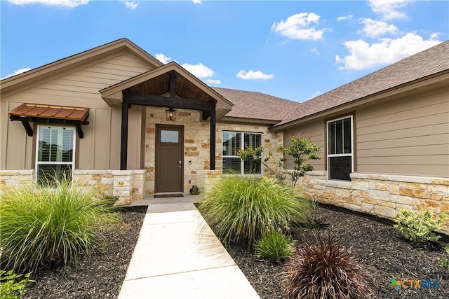 117 Aidan Ct, Burnet, TX 78611 - doorway to property with stone siding, board and batten siding, and roof with shingles