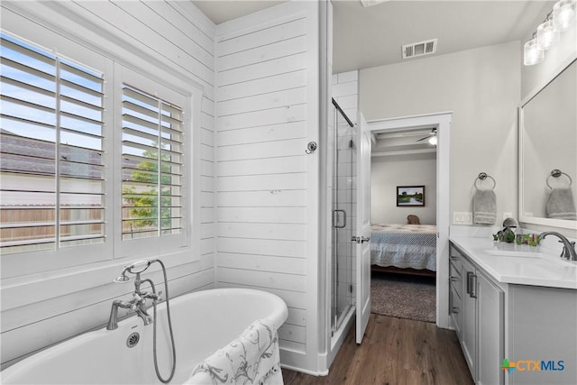 117 Aidan Ct, Burnet, TX 78611 - ensuite bathroom with vanity, wood finished floors, a soaking tub, and a stall shower