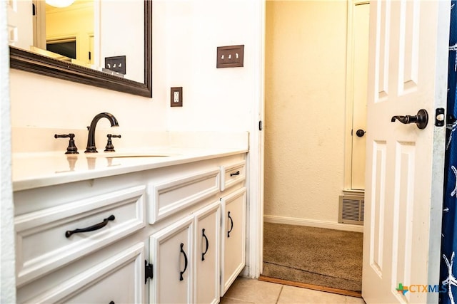 bathroom with tile patterned flooring and vanity