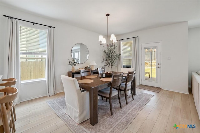 4648 Padula Dr, Round Rock, TX 78665 - dining area featuring a chandelier, plenty of natural light, and light wood-style floors