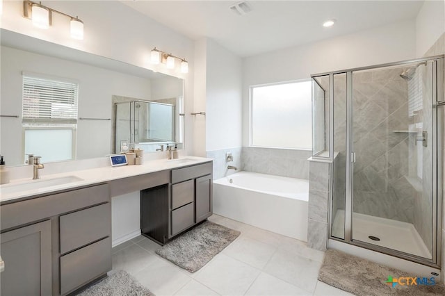 4648 Padula Dr, Round Rock, TX 78665 - full bath with double vanity, a bath, a stall shower, tile patterned floors, and recessed lighting