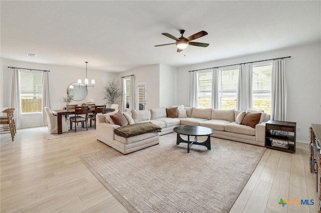 4648 Padula Dr, Round Rock, TX 78665 - living room with plenty of natural light, ceiling fan, light wood finished floors, and a chandelier