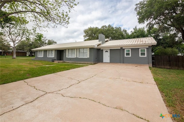 454 W Ward St, Goliad, TX 77963 - ranch-style home featuring driveway, a metal roof, and a chimney