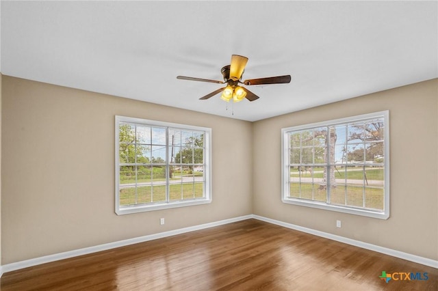 454 W Ward St, Goliad, TX 77963 - spare room featuring plenty of natural light, ceiling fan, and wood finished floors